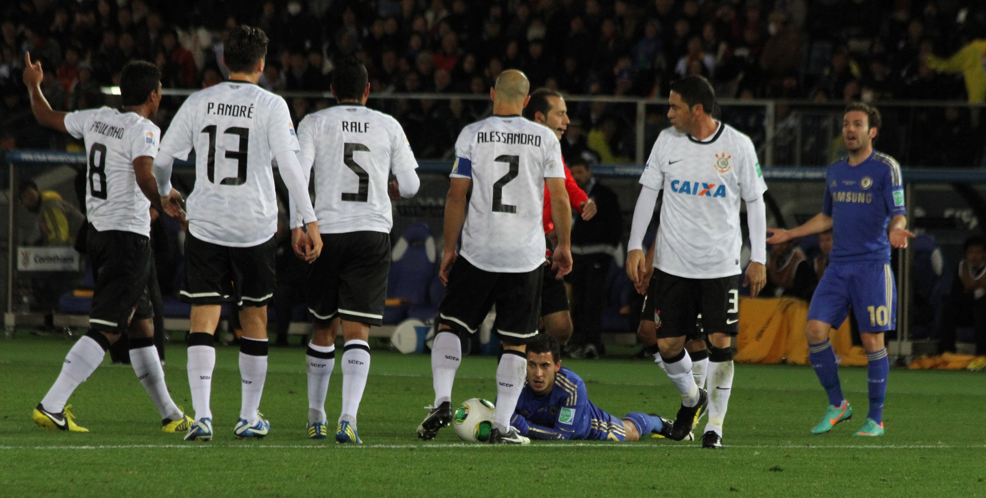 Eden Hazard tries to thread a pass between two Corinthians defenders in Yokohama.