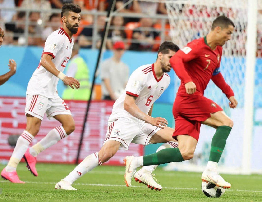 Cristiano Ronaldo scans for runners while Iran’s back line holds its shape.